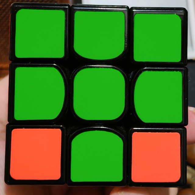 A clear photo showing all nine stickers of one cube face